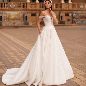 Vjenčanje haljine s otvorenim ramenima Linija Večernje Vjenčanje Haljine Bez rukava 2021 Bez naslona Vestidos De Novia s džepovima od perli